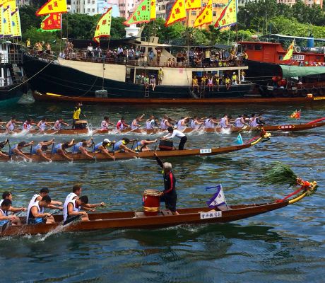 The paddling is not at all like crew.  The racers use very short, very fast strokes.  You can see they're all coordinated by the drummer at the head of the dragon.